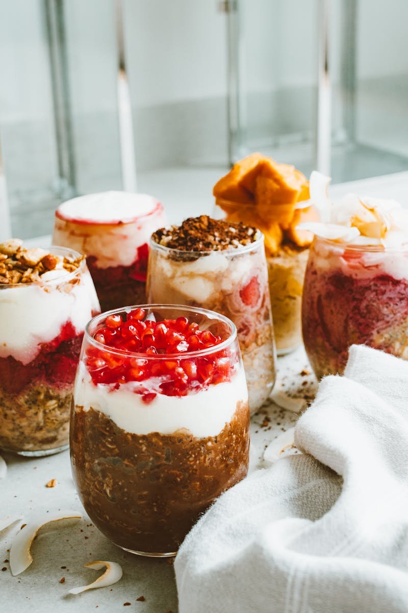 Delicious layers of yogurt, fruit, and toppings in elegant glasses for a perfect dessert.